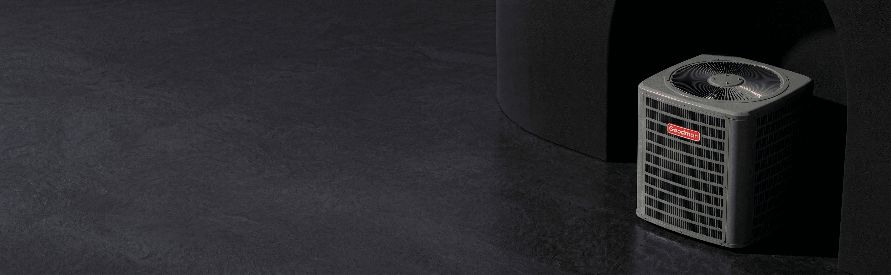 Goodman outdoor condenser in a dark showroom-style setting